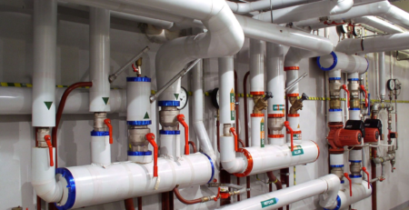 Hydronic heating and cooling piping system with pumps, valves, gauges, and controls