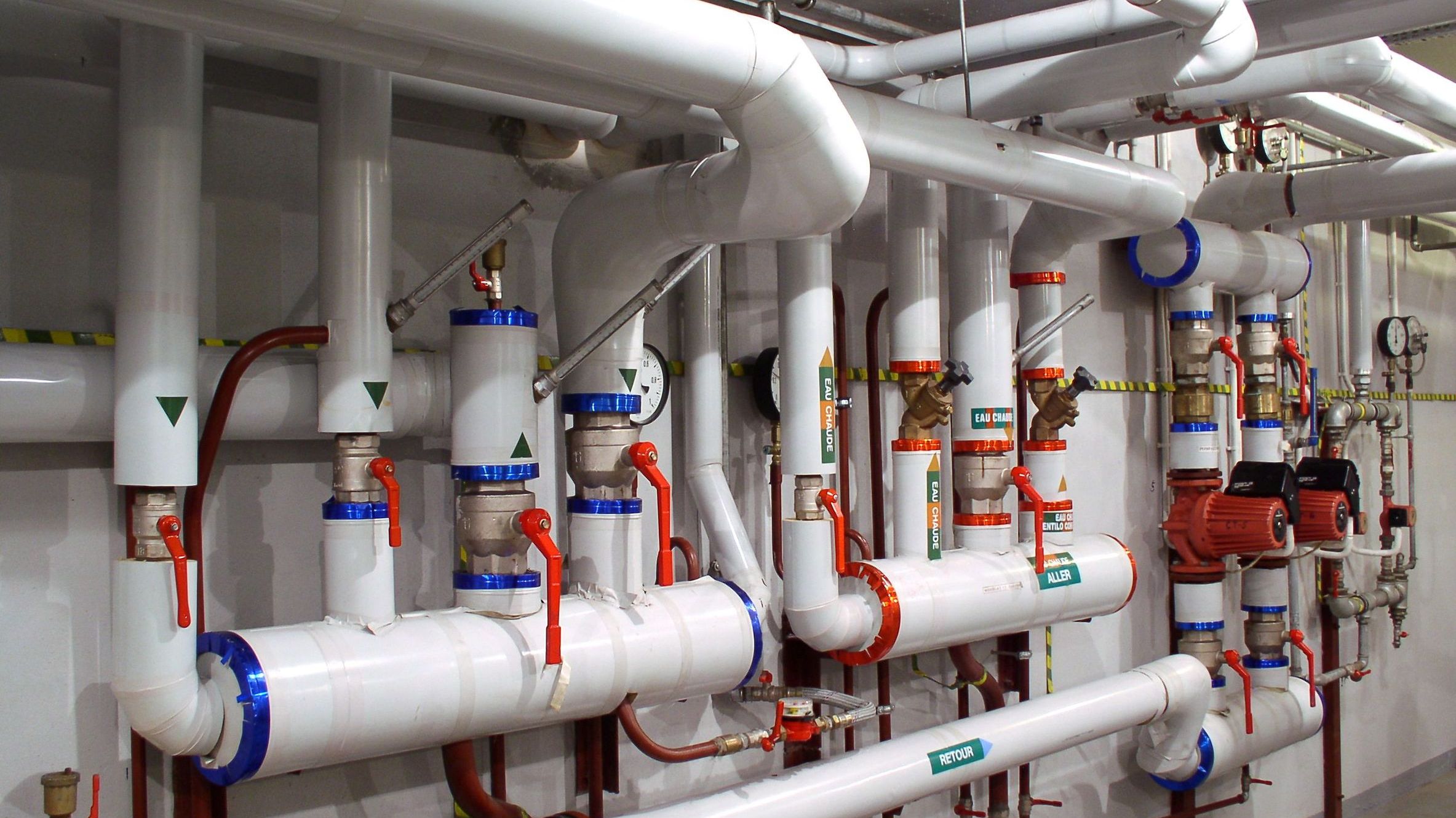 Hydronic heating and cooling piping system with pumps, valves, gauges, and controls